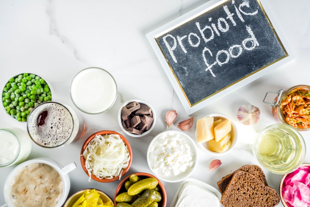 Super Healthy Probiotic Fermented Food Sources, drinks, ingredients, on white marble background copy space top view 