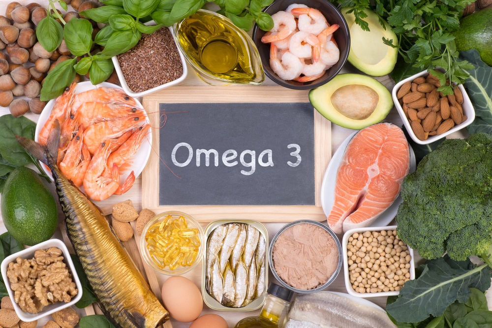 Food rich in Omega 3 fatty acids, top view with a small blackboard